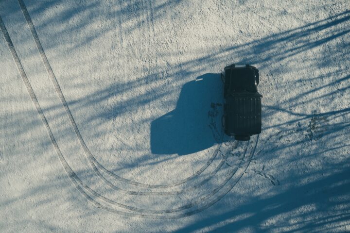 aerial photography of black SUV on dirt road at daytime